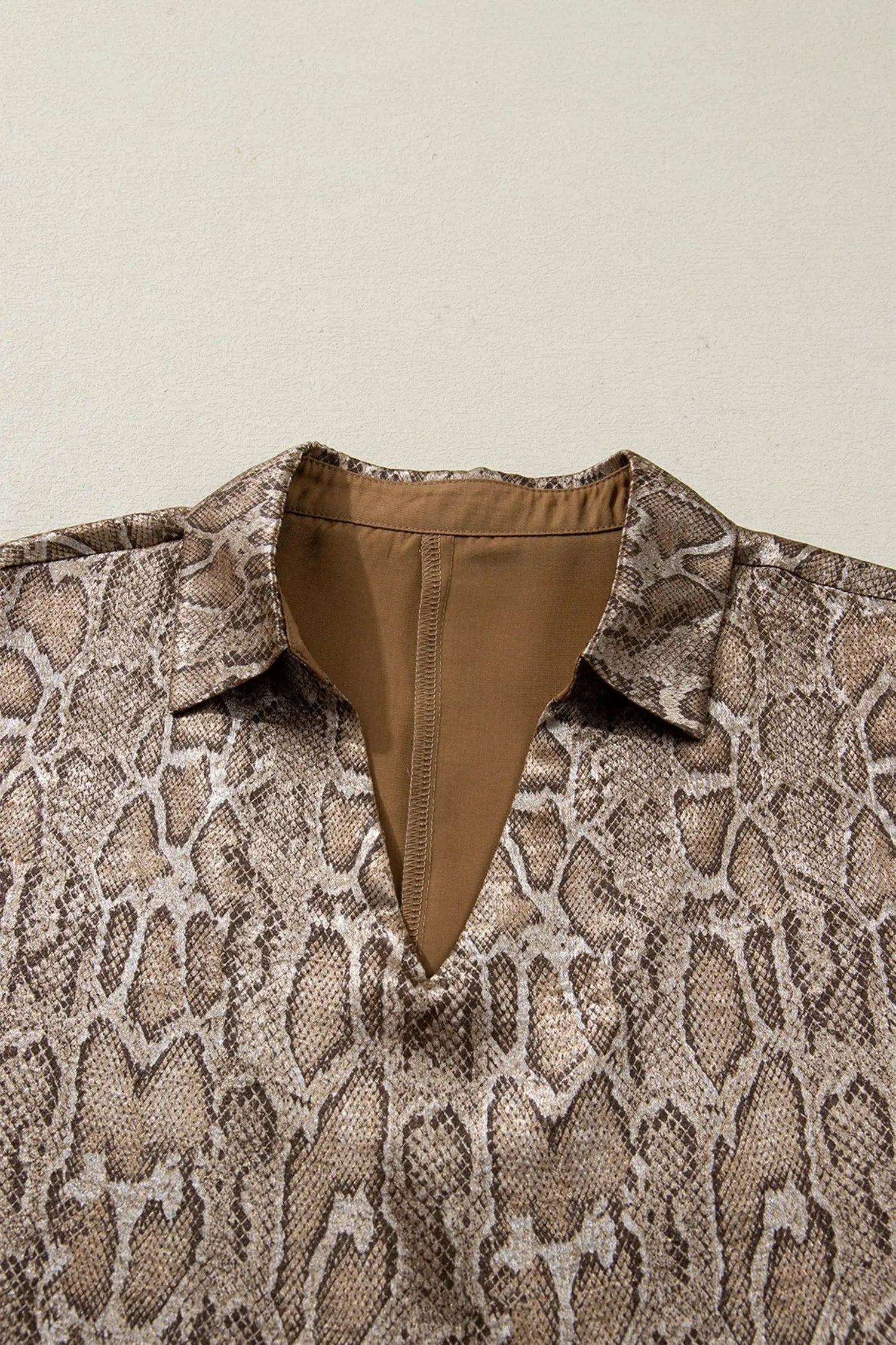 Metallic leopard print detail close-up on brown polo collar blouse | Fashionfitz