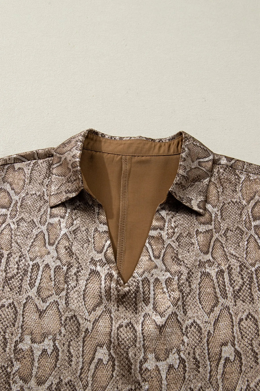 Metallic leopard print detail close-up on brown polo collar blouse | Fashionfitz
