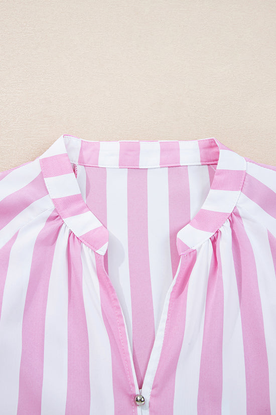 Close-up of a pink and white striped garment with a beige background