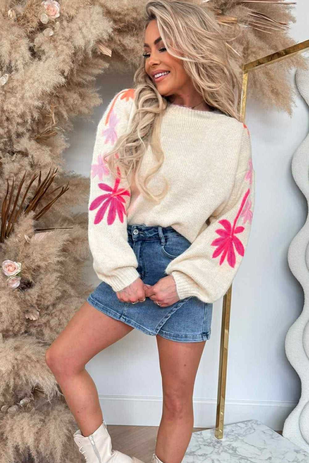 Cream Women's Floral Embroidered Sleeve Jumper with vibrant floral knit, paired with a denim mini skirt and boots for a stylish fall look.