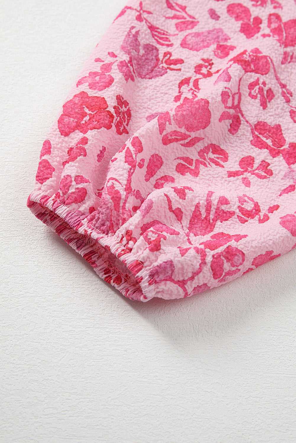 Neckline detail of Pink Floral Lightweight Blouse with gathered back and v-cut front for a feminine silhouette.