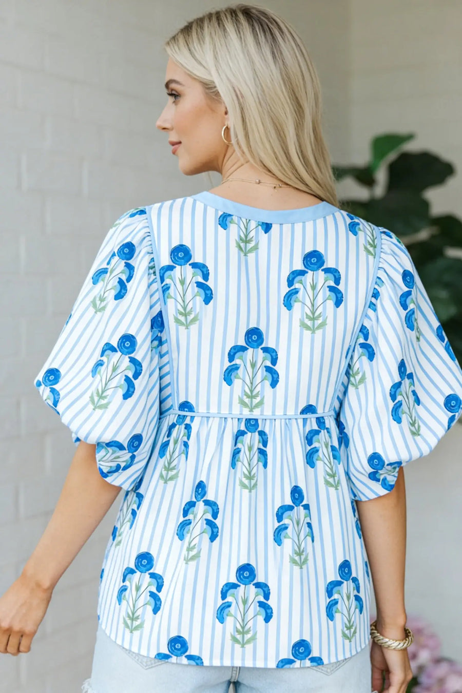 Close-up of Floral Print Tie Neck Puff Sleeve Blouse showing self-tie V-neck detail and sky blue floral print — Fashionfitz