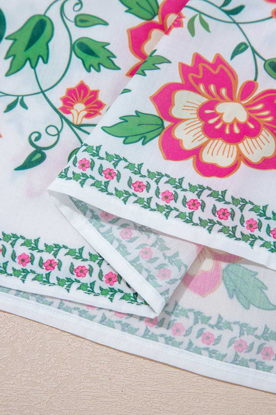 Hemline close-up of White Floral Mandarin Maxi Dress featuring floral border and lightweight fabric for breezy spring style.