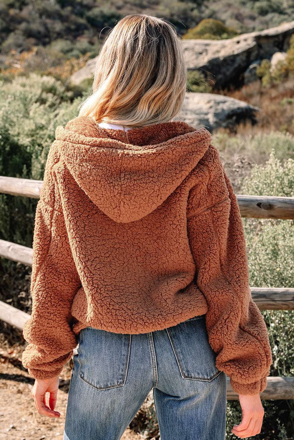 Back view of Women's Zip‑Up Sherpa Hoodie Jacket in soft brown sherpa fabric, showcasing relaxed fit and hood detail.