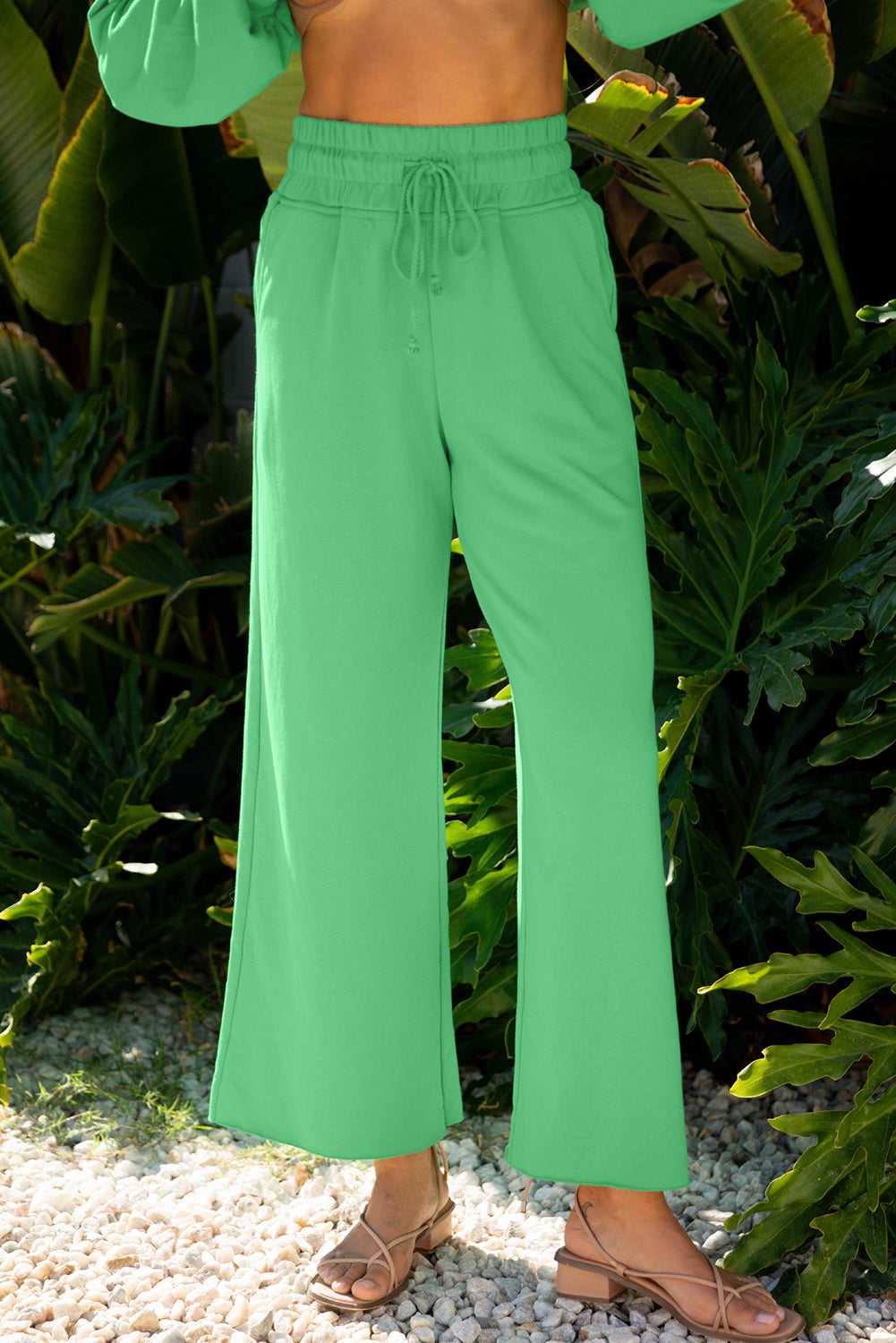 Close-up of green wide-leg pants from the Drop Crop Set, featuring drawstring waist and soft fabric for cozy loungewear appeal.