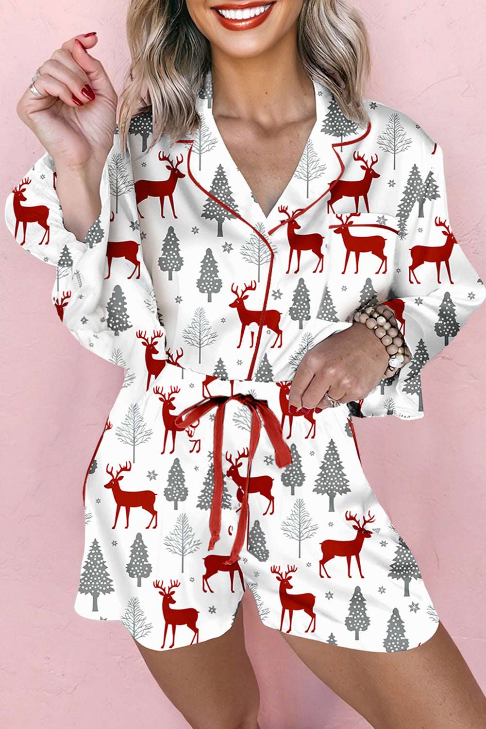 Ladies White Christmas Print Velvet Trim Pyjamas with red reindeer and grey tree design, featuring red velvet waist tie and piping.