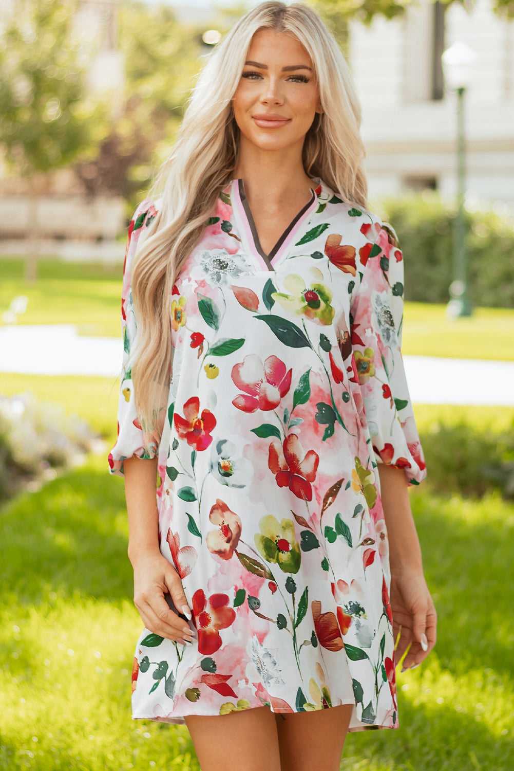Model smiling in Floral Shift Dress - Casual Elegance, highlighting colorful floral print and easygoing Southern Belle style.