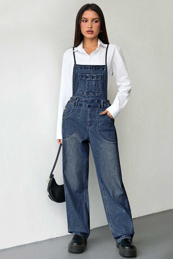 Versatile dark blue baggy denim overalls for women with a solid color design and medium elasticity. Styled with black platform shoes.