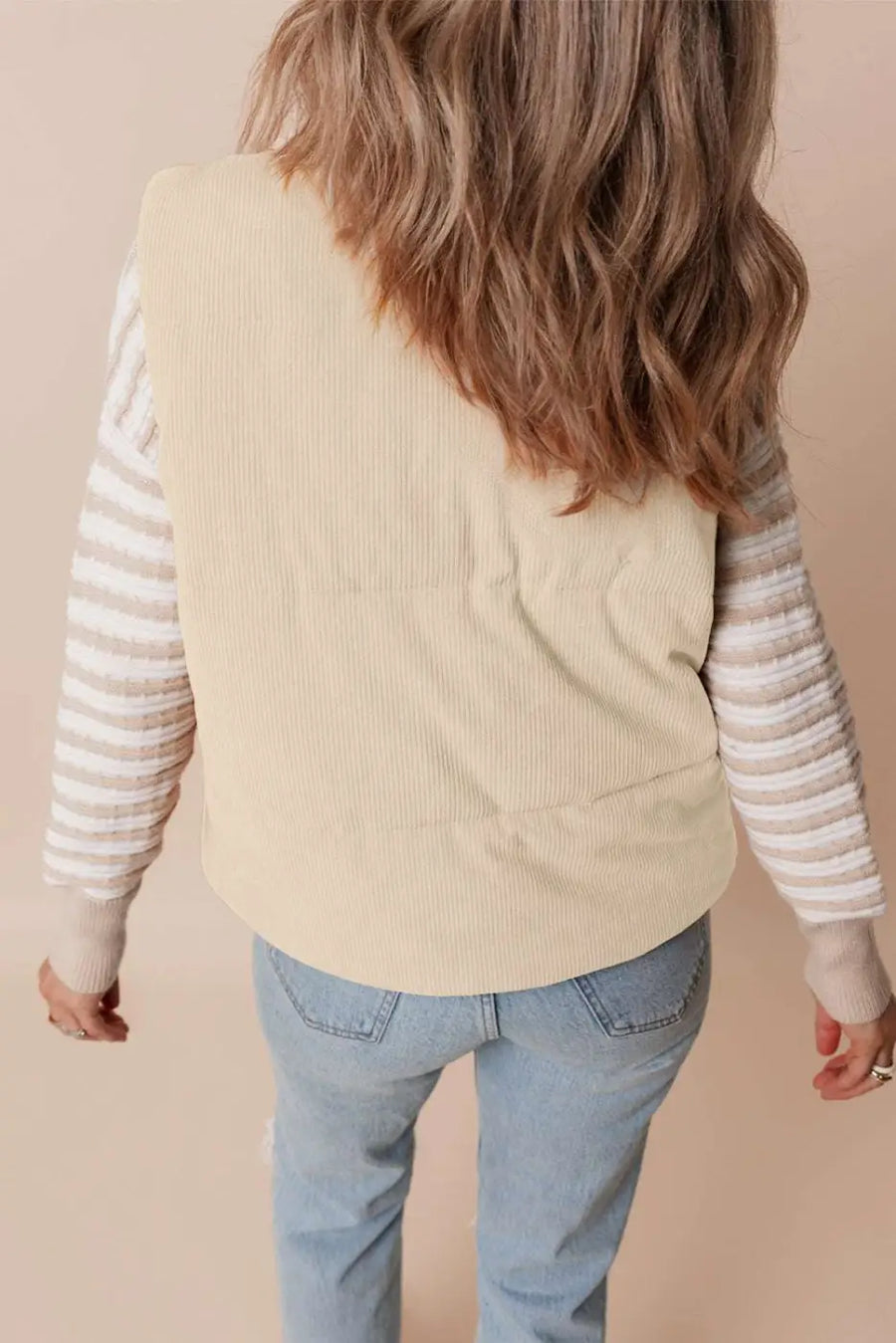Back view of beige corduroy puffer gilet for women, showcasing solid color and quilted texture in winter vest design.