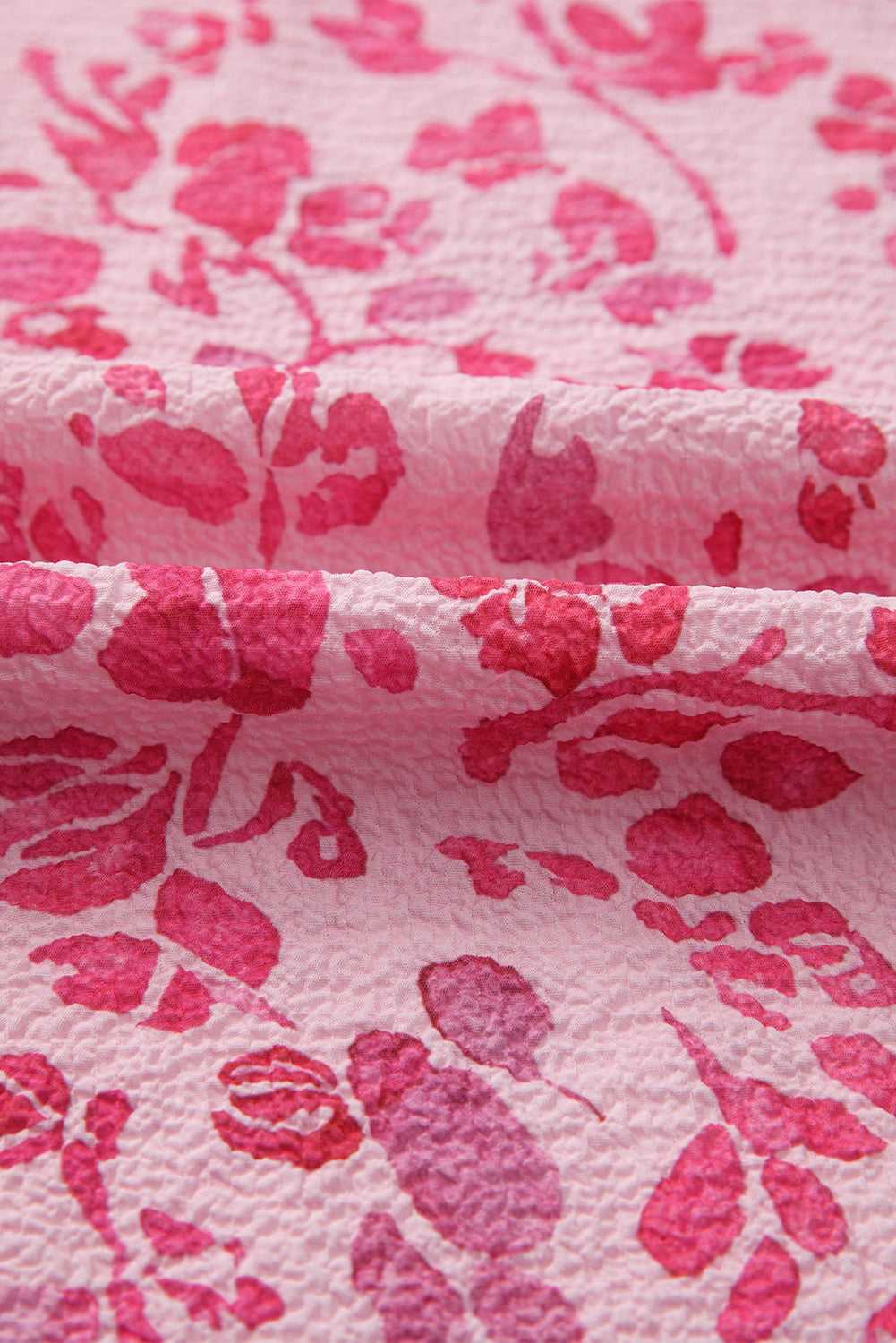 Hem detail of Pink Floral Lightweight Blouse, featuring soft pink floral fabric and clean stitching.