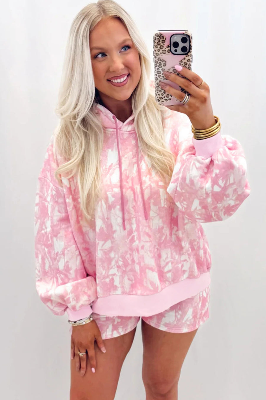 Abstract print hoodie and slim shorts set in pink — full-length model lifestyle shot