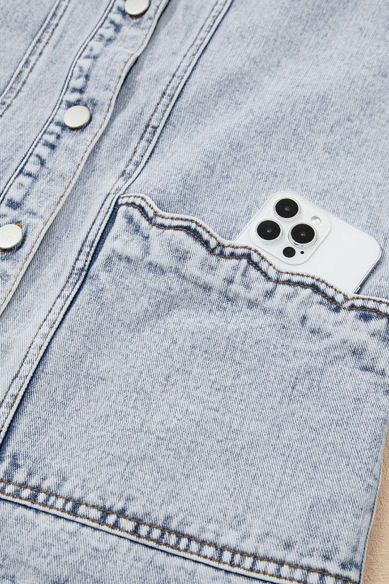 Front pocket of Beau Blue Scallop‑Trim Denim Waistcoat holding a smartphone, demonstrating practical storage in stylish outerwear.
