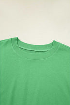 Close-up of green Drop Crop Set neckline with ribbed trim, offering a detailed look at the top's casual design.