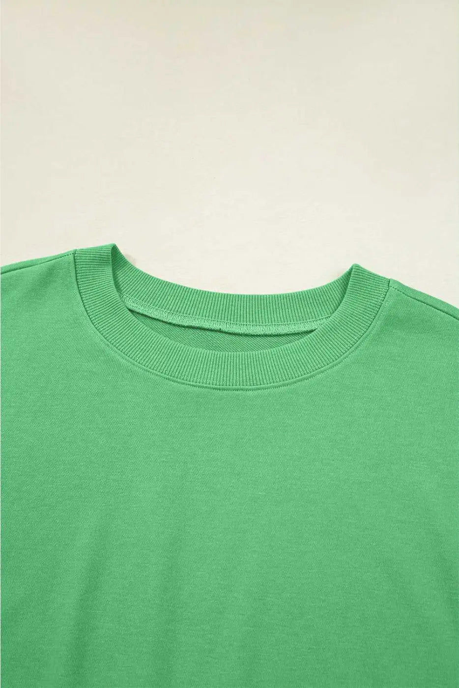 Close-up of green Drop Crop Set neckline with ribbed trim, offering a detailed look at the top's casual design.