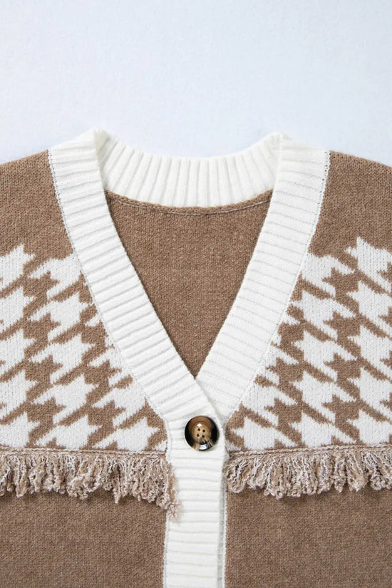 Close-up of khaki houndstooth knit cardigan neckline with white ribbed trim and button detail. Soft knit texture for fall layering.