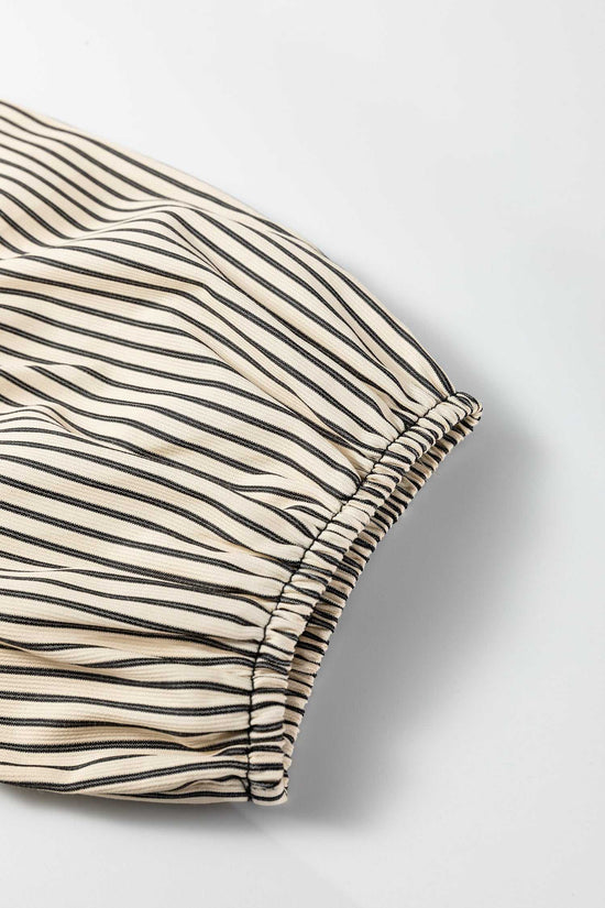 Detail of puff sleeve on Monochrome Striped Puff Sleeve Mini Dress with elastic hem and lightweight striped fabric for summer wear.