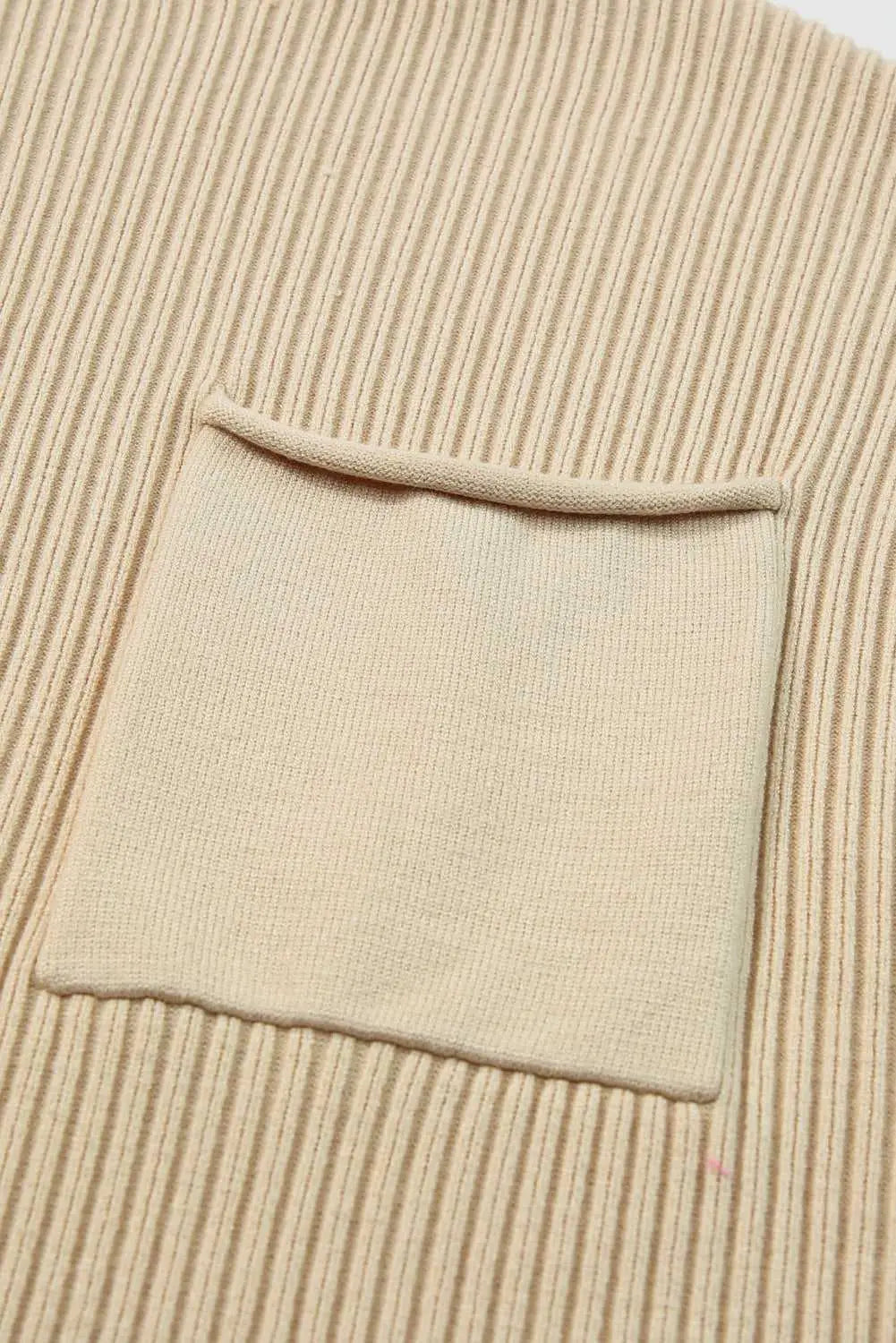 Detail of front chest pocket on Ribbed Knit Short Sleeve Sweater, showcasing fine ribbed knit texture and minimalist design.