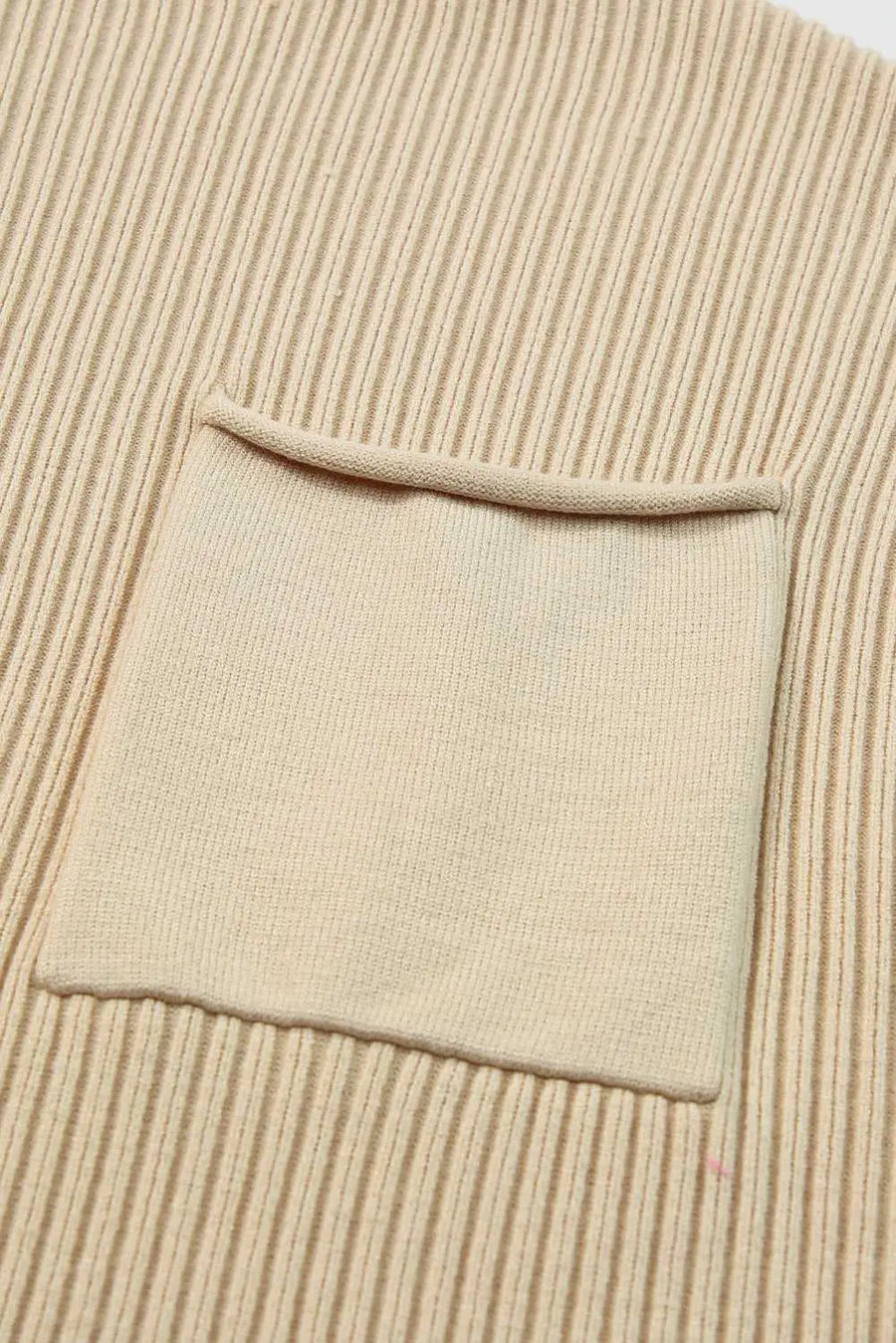 Detail of front chest pocket on Ribbed Knit Short Sleeve Sweater, showcasing fine ribbed knit texture and minimalist design.