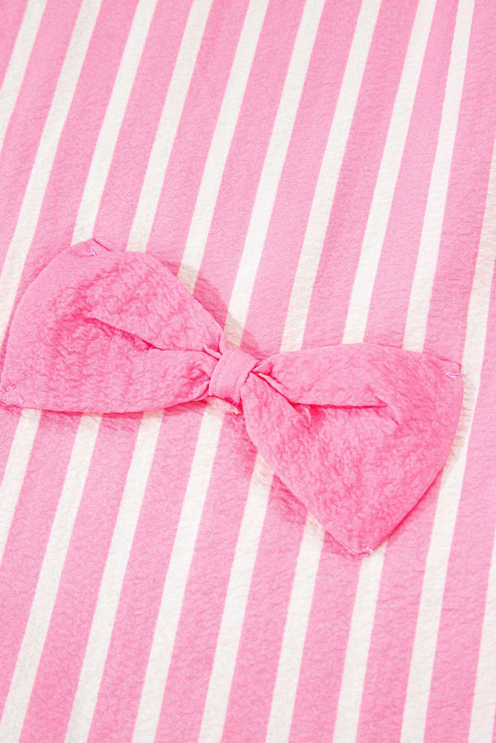 Close-up of pink stripe pattern and bow detail