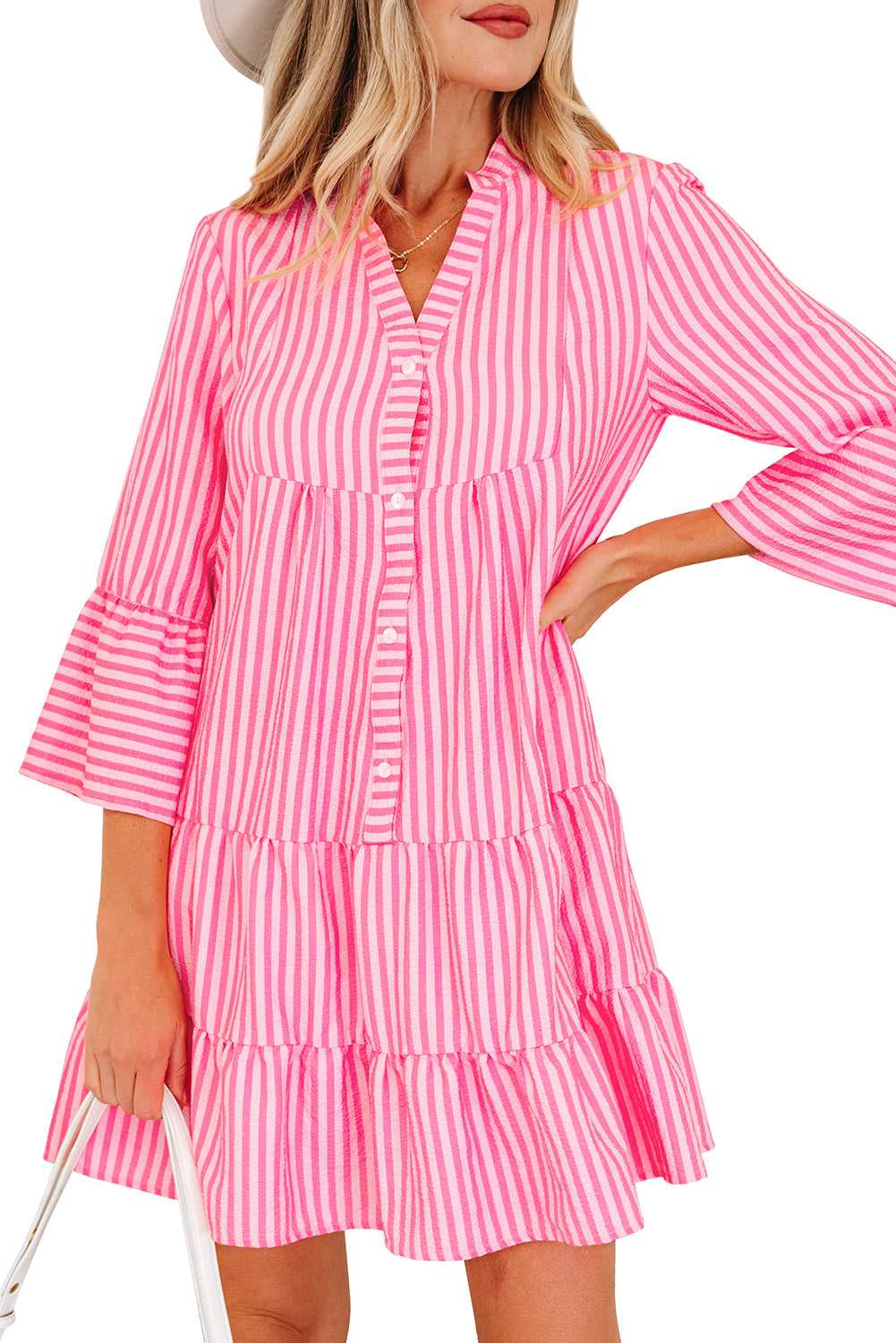 Close-up of pink striped tiered flowy mini dress women, casual spring style, button front, notched neck, apparel and accessories clothing dresses