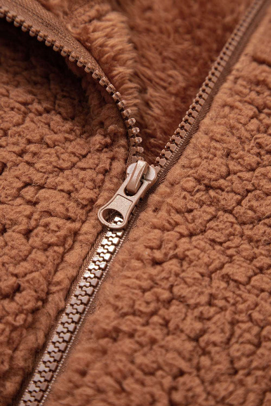 Macro shot of zipper on Women's Zip‑Up Sherpa Hoodie Jacket, highlighting durable hardware and soft fleece lining.