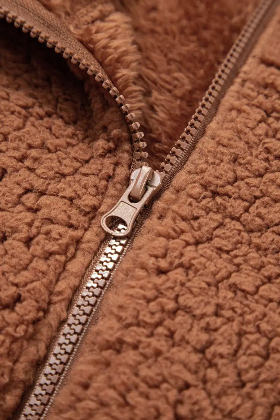 Macro shot of zipper on Women's Zip‑Up Sherpa Hoodie Jacket, highlighting durable hardware and soft fleece lining.