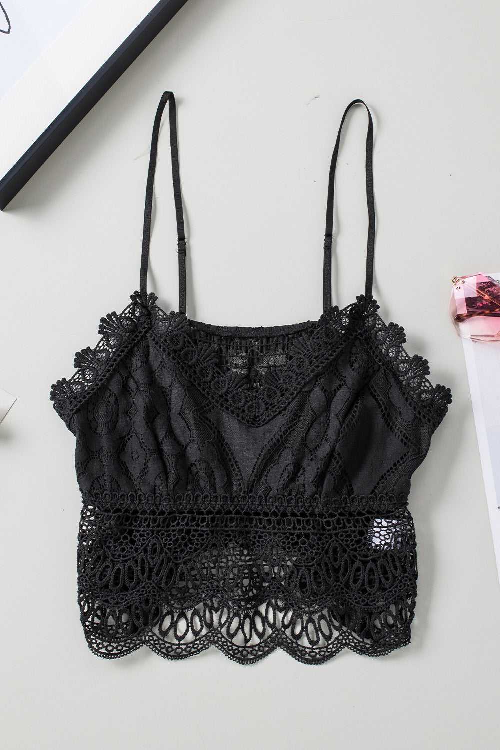 Flat lay of the Black Crochet Lace Bralette Crop Top showing intricate lacework, adjustable straps, and scalloped hem design.