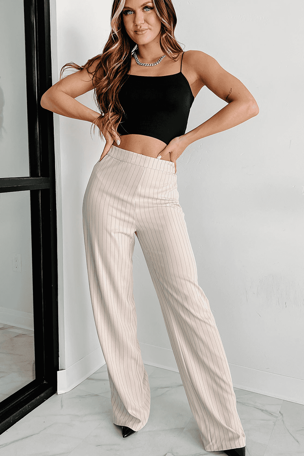 Full outfit featuring black skinny fit crop top and beige pinstripe wide-leg pants, perfect for casual or evening wear.