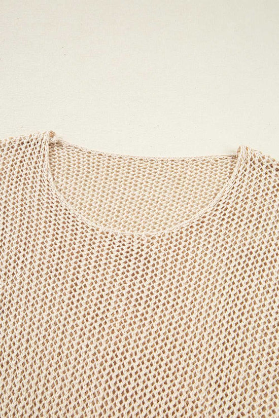 Close-up of a beige knitted sweater on a light beige background