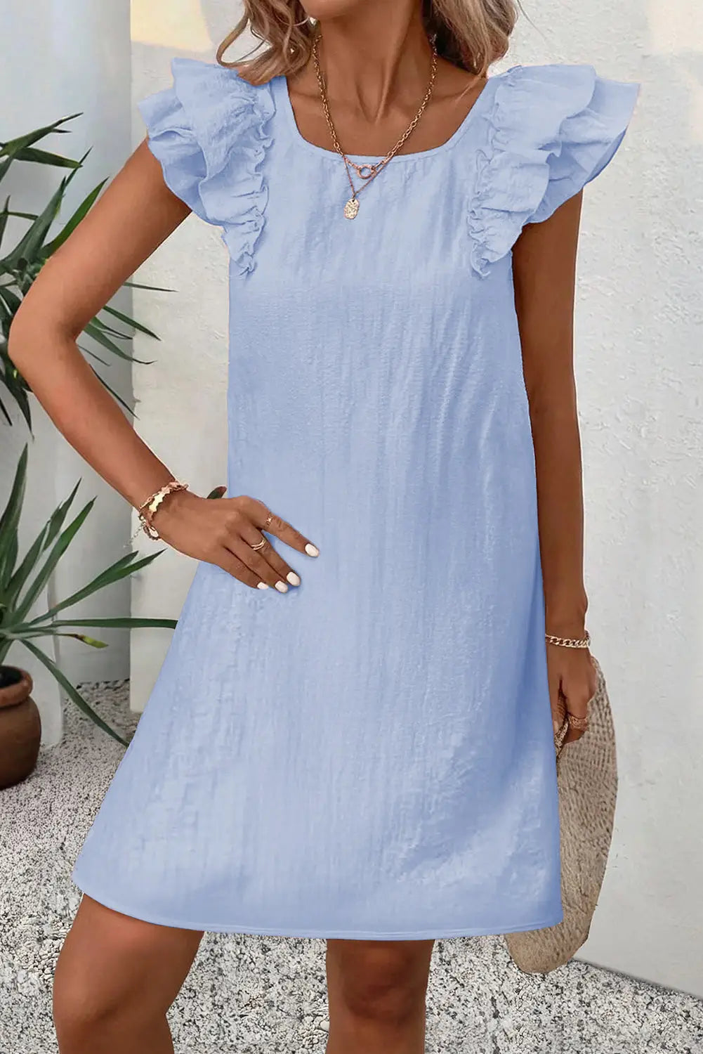 Light pink textured flutter sleeve square neck bow back mini dress