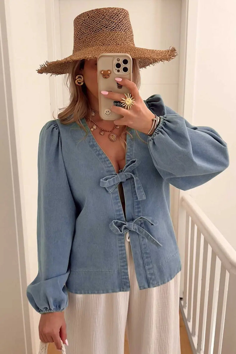 Back view of Blue Denim Tie Knot Puff Sleeve Top showing long sleeve silhouette and V-neckline — Fashionfitz