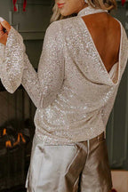 Open back sequin party top with shimmering silver fabric and flirty bell sleeves, styled for festive evening wear in the UK market.