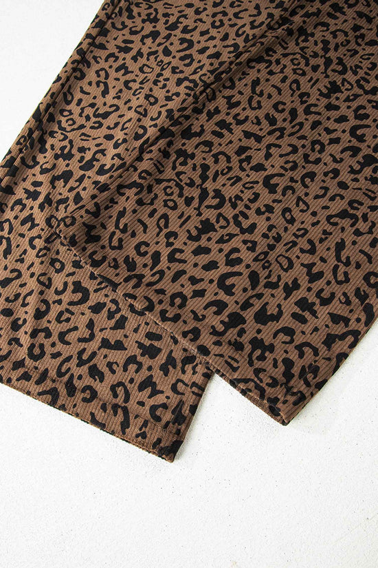 Flat lay of leopard corduroy trousers women in brown, showing detailed hem and all-over animal print for stylish fall outfits.