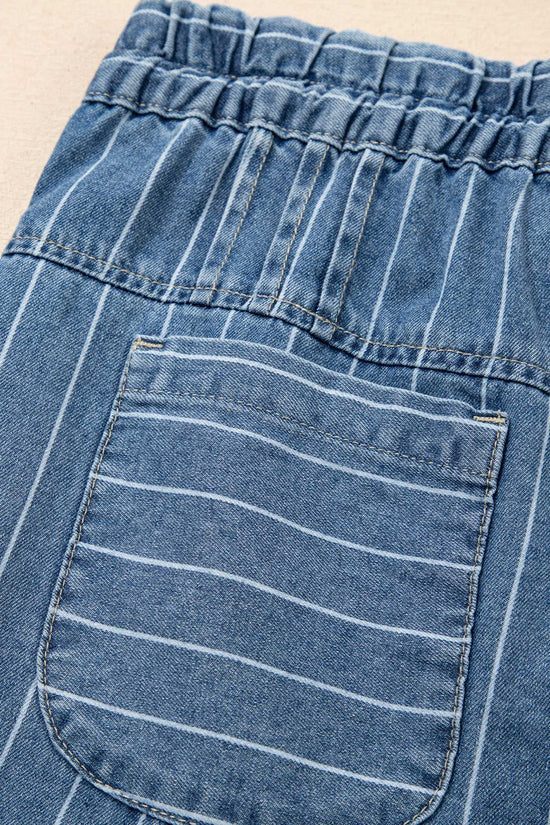 Detail of back pocket and elastic waistband on pinstripe denim trousers, highlighting the casual and functional design.