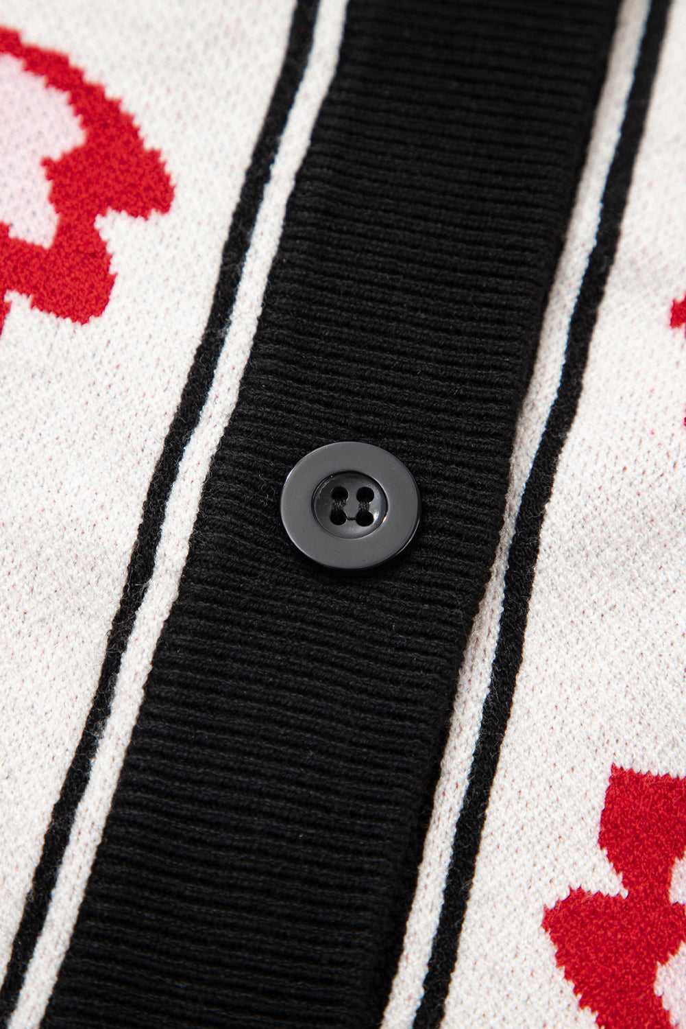 Close-up of floral buttons on beige knit cardigan