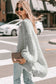 Side view of light grey oversized cardigan in chunky knit, ideal for layering in autumn street style looks.