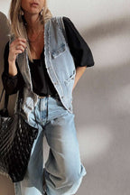 Relaxed fit Beau Blue Denim Waistcoat with Frayed Edges worn over a black blouse and light denim jeans, styled for a casual streetwear outfit.