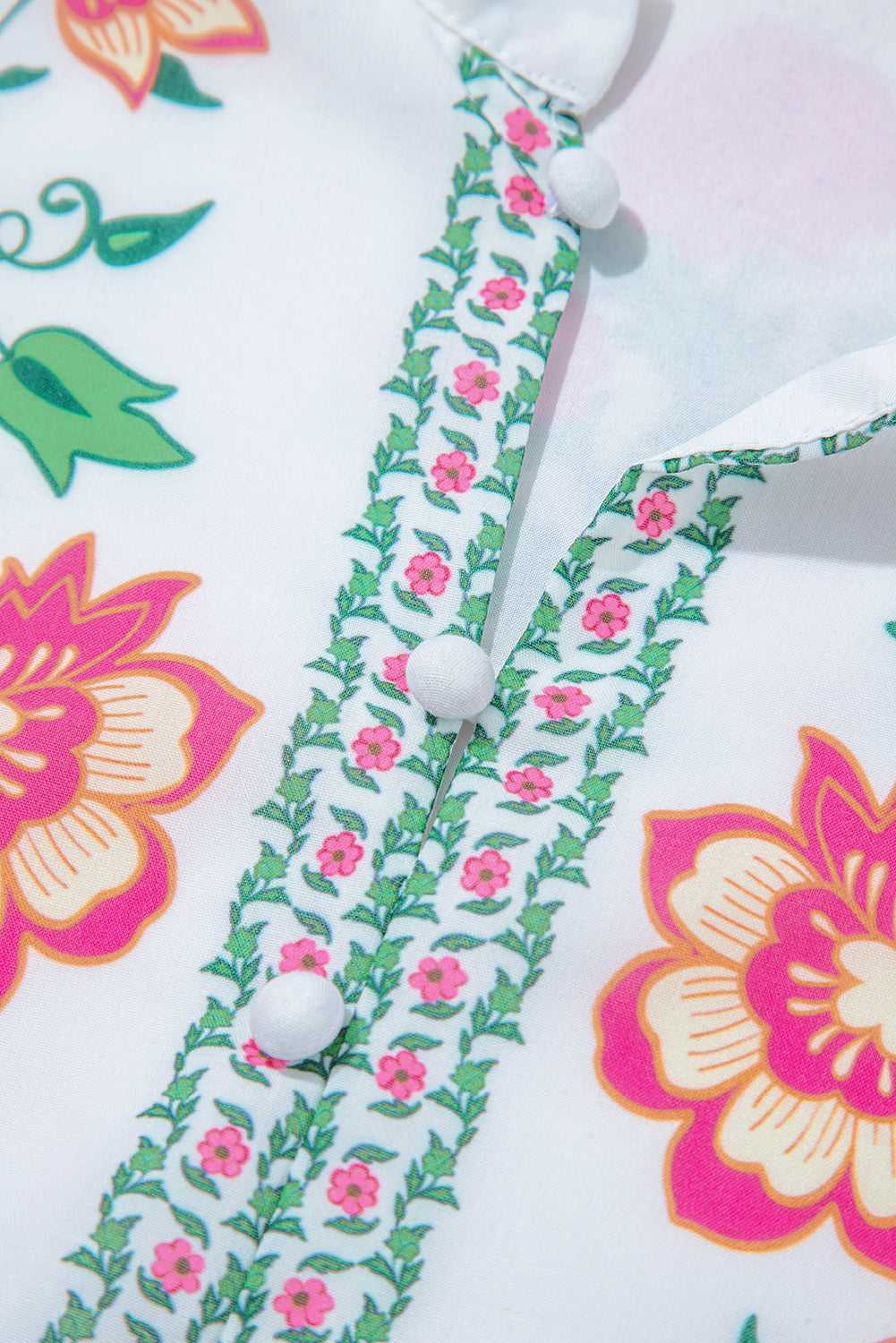 Detailed view of front buttons and floral trim on White Floral Mandarin Maxi Dress, highlighting craftsmanship and spring-inspired design.