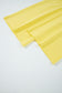 Wide-leg hem detail of yellow Drop Crop Pants, emphasizing flowy silhouette and relaxed fit for fall fashion.