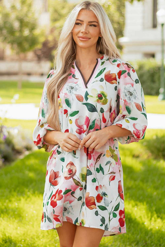 Front view of model wearing Floral Shift Dress - Casual Elegance, featuring vibrant blooms and contrast trim neckline in a relaxed fit.