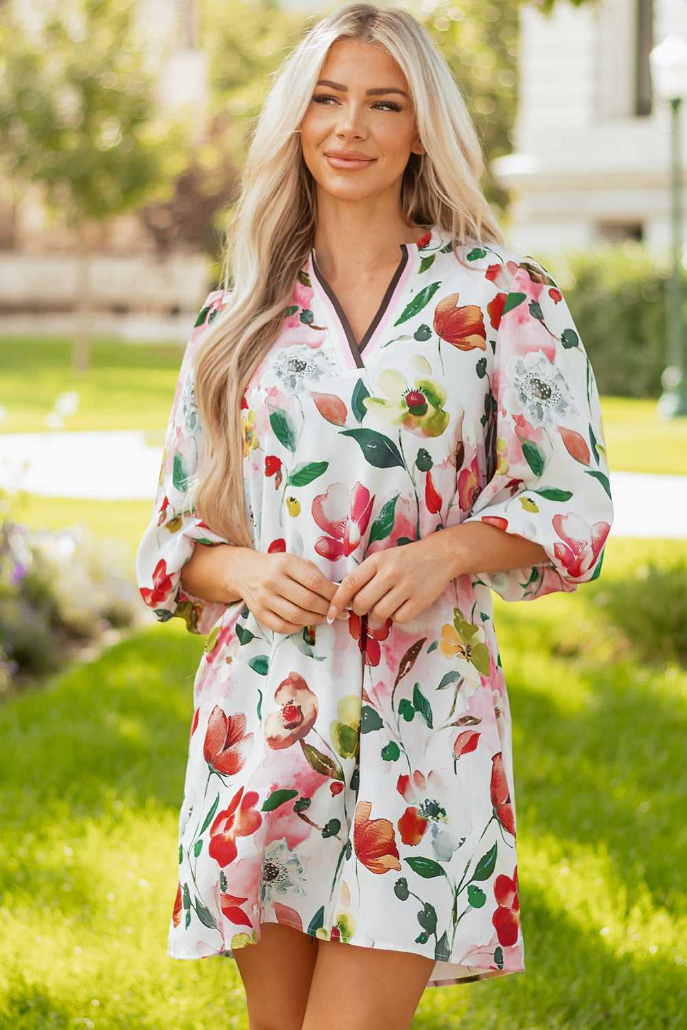 Front view of model wearing Floral Shift Dress - Casual Elegance, featuring vibrant blooms and contrast trim neckline in a relaxed fit.