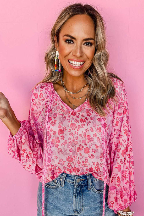 Model wearing Pink Floral Lightweight Blouse with layered necklaces, showcasing its vibrant floral pattern and breezy fabric.