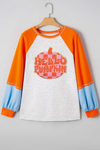 Flat lay of Hello Pumpkin sweatshirt on hanger, highlighting orange raglan sleeves, blue cuffs, and central pumpkin graphic for fall wardrobe.