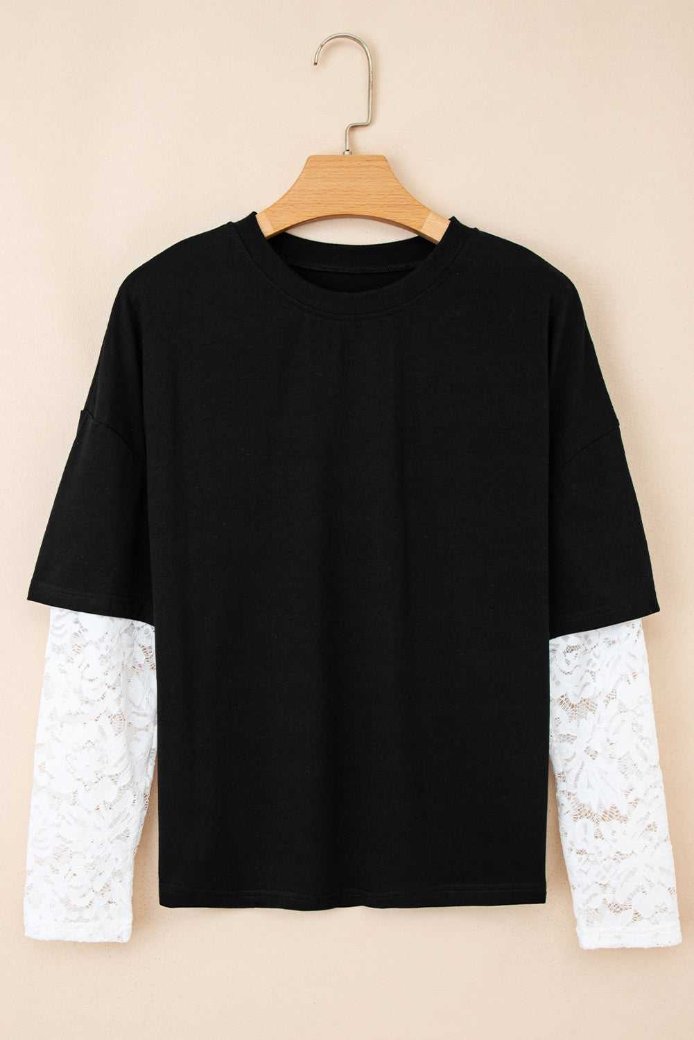 Front view of the Lace Sleeve Drop T-Shirt - Soft & Comfy | FashionFitz, featuring black body and white floral lace long sleeves on hanger.