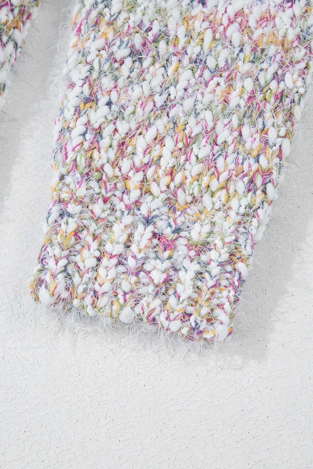 Sleeve cuff detail of white confetti knit cardigan for women, showing ribbed finish and colorful yarn blend.