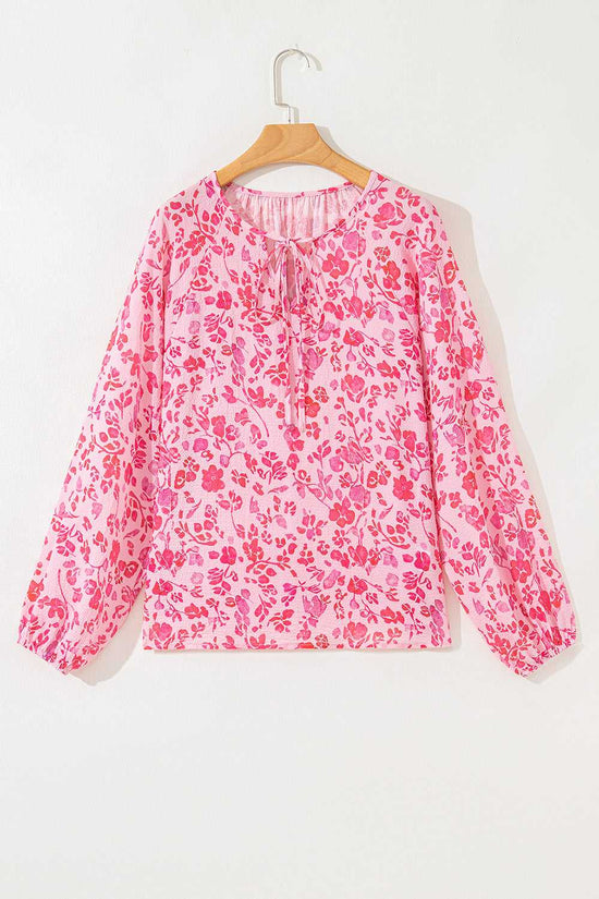 Flat lay of Pink Floral Lightweight Blouse on hanger, highlighting its long sleeves and pink floral print.