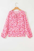 Flat lay of Pink Floral Lightweight Blouse on hanger, highlighting its long sleeves and pink floral print.