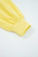 Close-up of yellow Drop Crop Set sleeve cuff with ribbed finish, emphasizing casual style and snug fit.