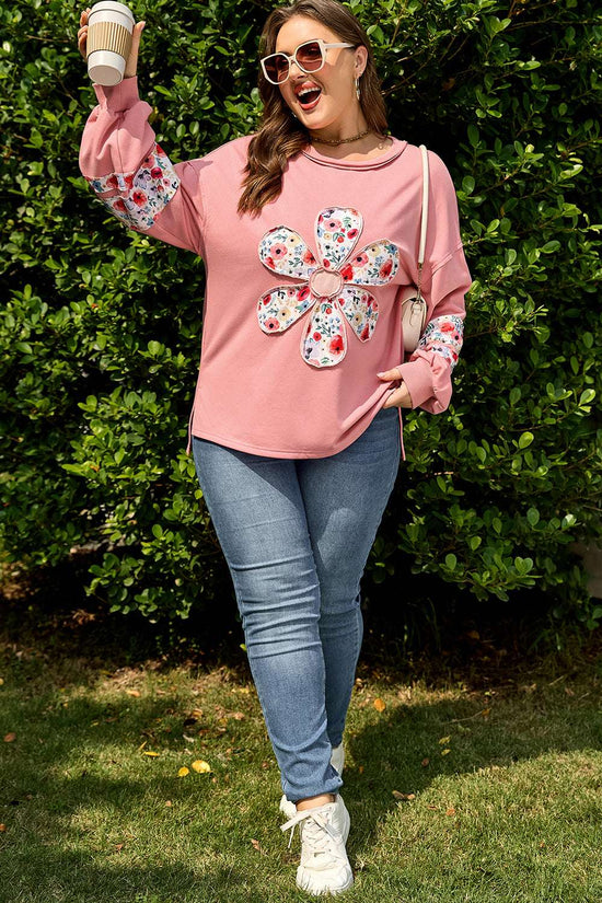 Full body shot of woman wearing Curve Blush Peach Floral Appliqué Sweatshirt for Women with jeans and sneakers, showcasing casual plus size outfit.