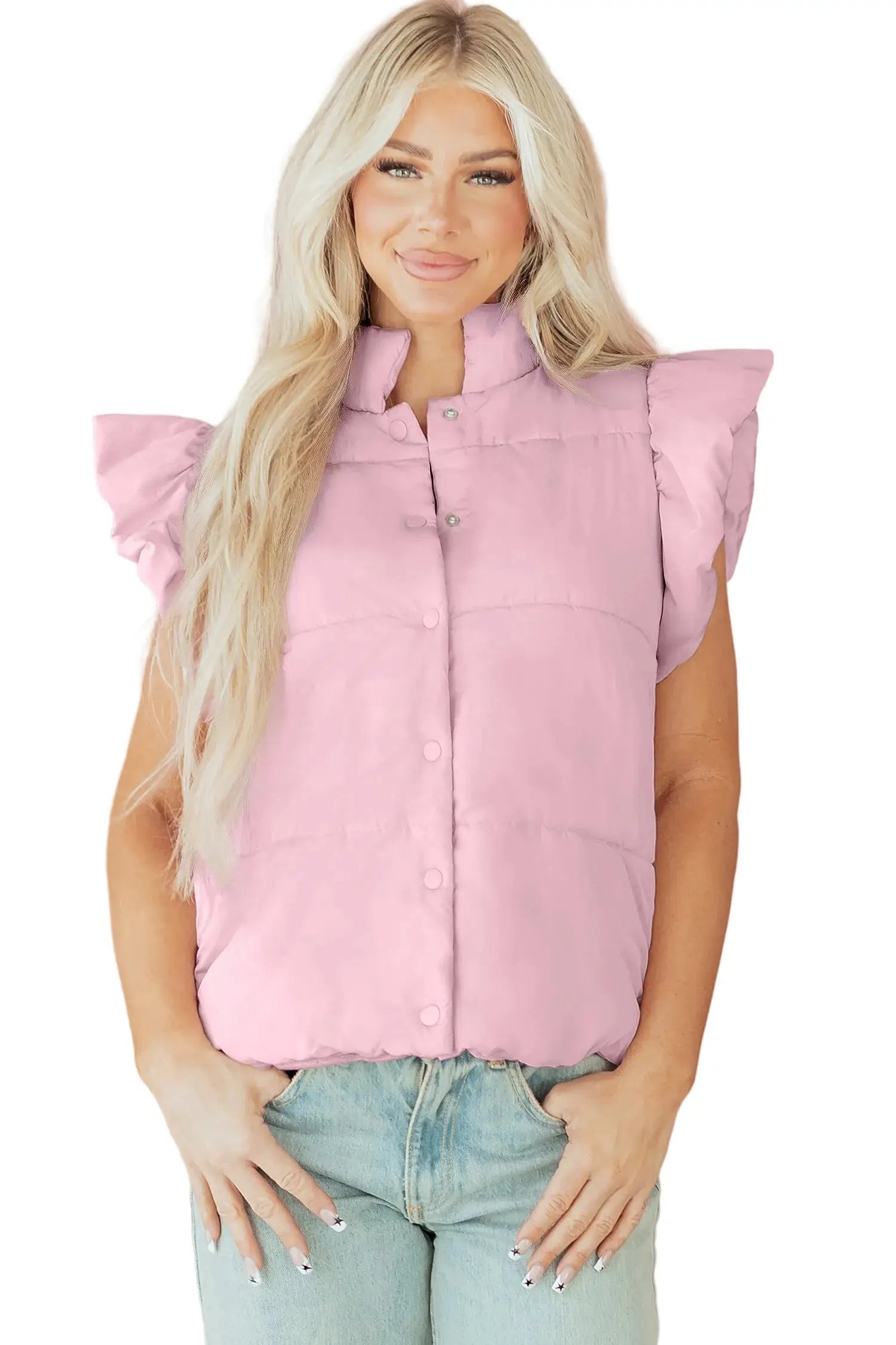 Woman wearing a pink puffer vest against a pink background with heart shapes.